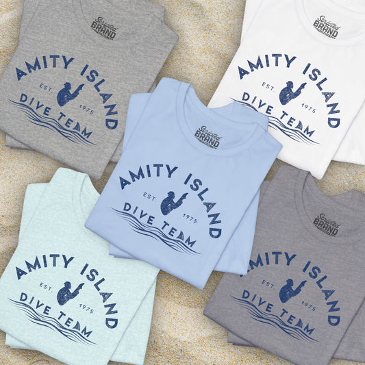 Folded Bella+Canvas t-shirts with vintage-style Amity Island Dive Team logo, inspired by the movie Jaws.