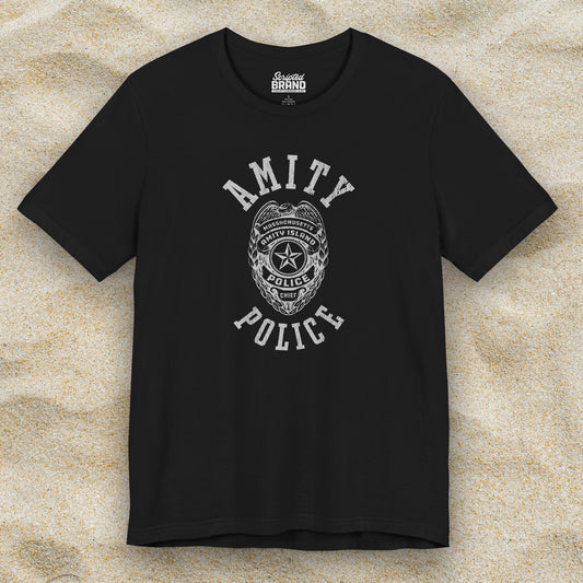 Front view of a black colored Soft unisex Bella+Canvas 3001 short-sleeve t-shirt featuring an Amity Island Police logo graphic, designed by ScriptedBrand, and  inspired by the movie Jaws in a vintage distressed style.