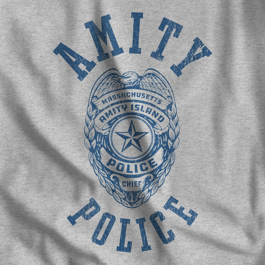 Closeup of heather gray vintage distressed t-shirt with an Amity Island Police logo graphic from the movie Jaws.