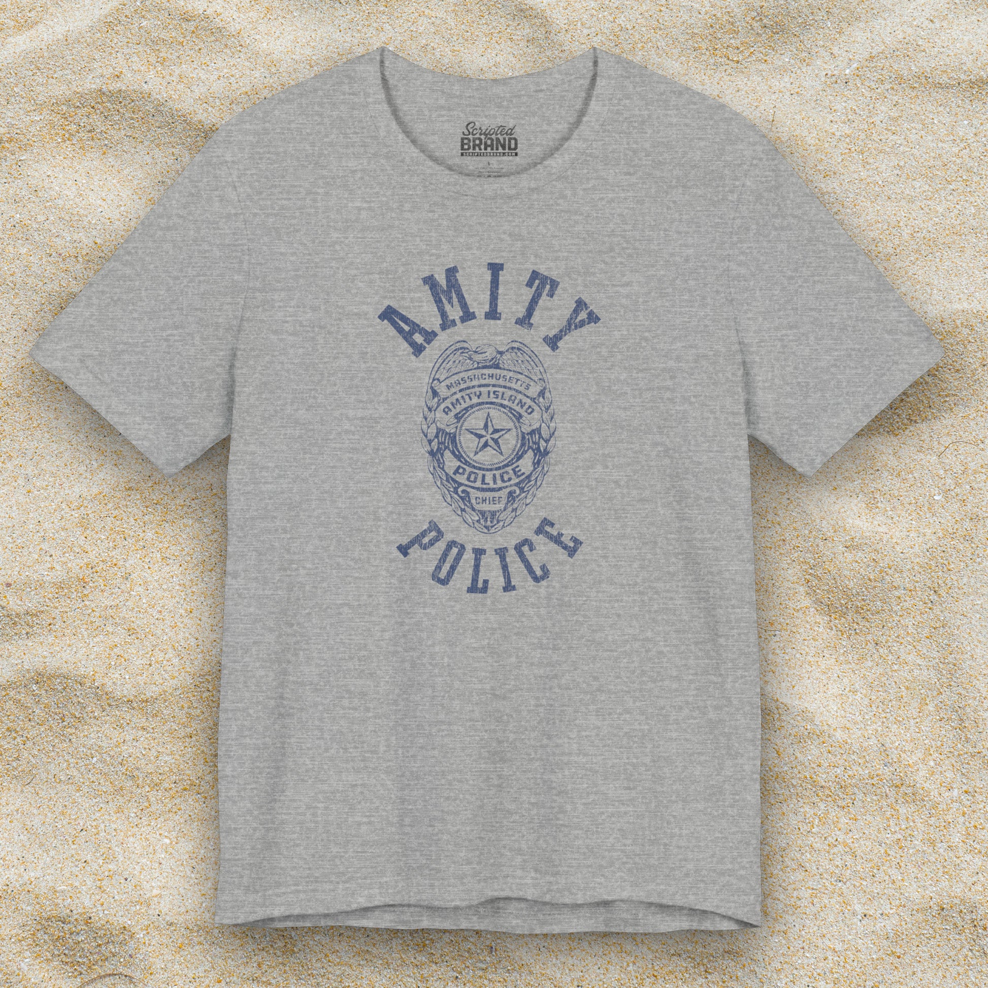 Front view of an athletic heather grey colored Soft unisex Bella+Canvas 3001 short-sleeve t-shirt featuring an Amity Island Police logo graphic, designed by ScriptedBrand, and  inspired by the movie Jaws in a vintage distressed style.