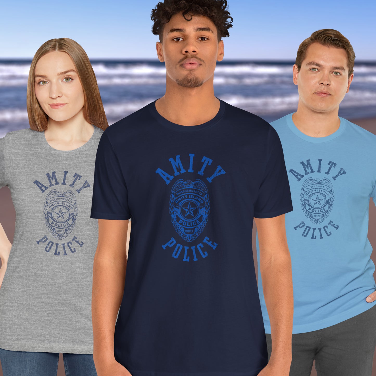 3 models wearing Soft unisex Bella+Canvas 3001 short-sleeve t-shirts featuring an Amity Island Police logo graphic, designed by ScriptedBrand, and  inspired by the movie Jaws in a vintage distressed style.