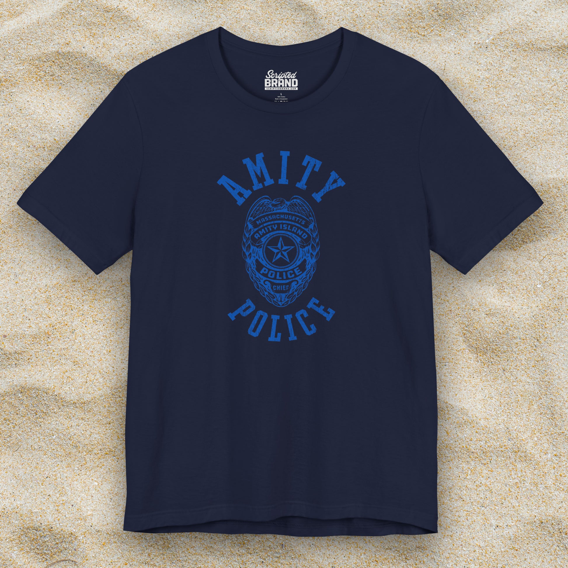 Front view of a navy blue colored Soft unisex Bella+Canvas 3001 short-sleeve t-shirt featuring an Amity Island Police logo graphic, designed by ScriptedBrand, and  inspired by the movie Jaws in a vintage distressed style.