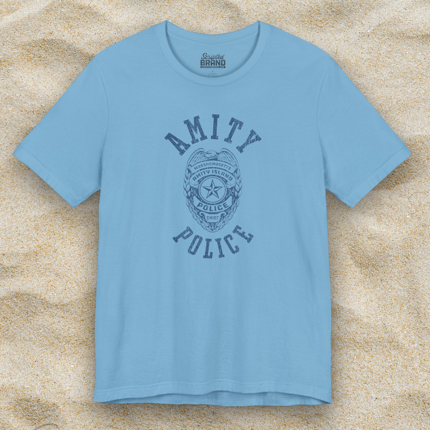 Front view of an ocean blue colored Soft unisex Bella+Canvas 3001 short-sleeve t-shirt featuring an Amity Island Police logo graphic, designed by ScriptedBrand, and  inspired by the movie Jaws in a vintage distressed style.