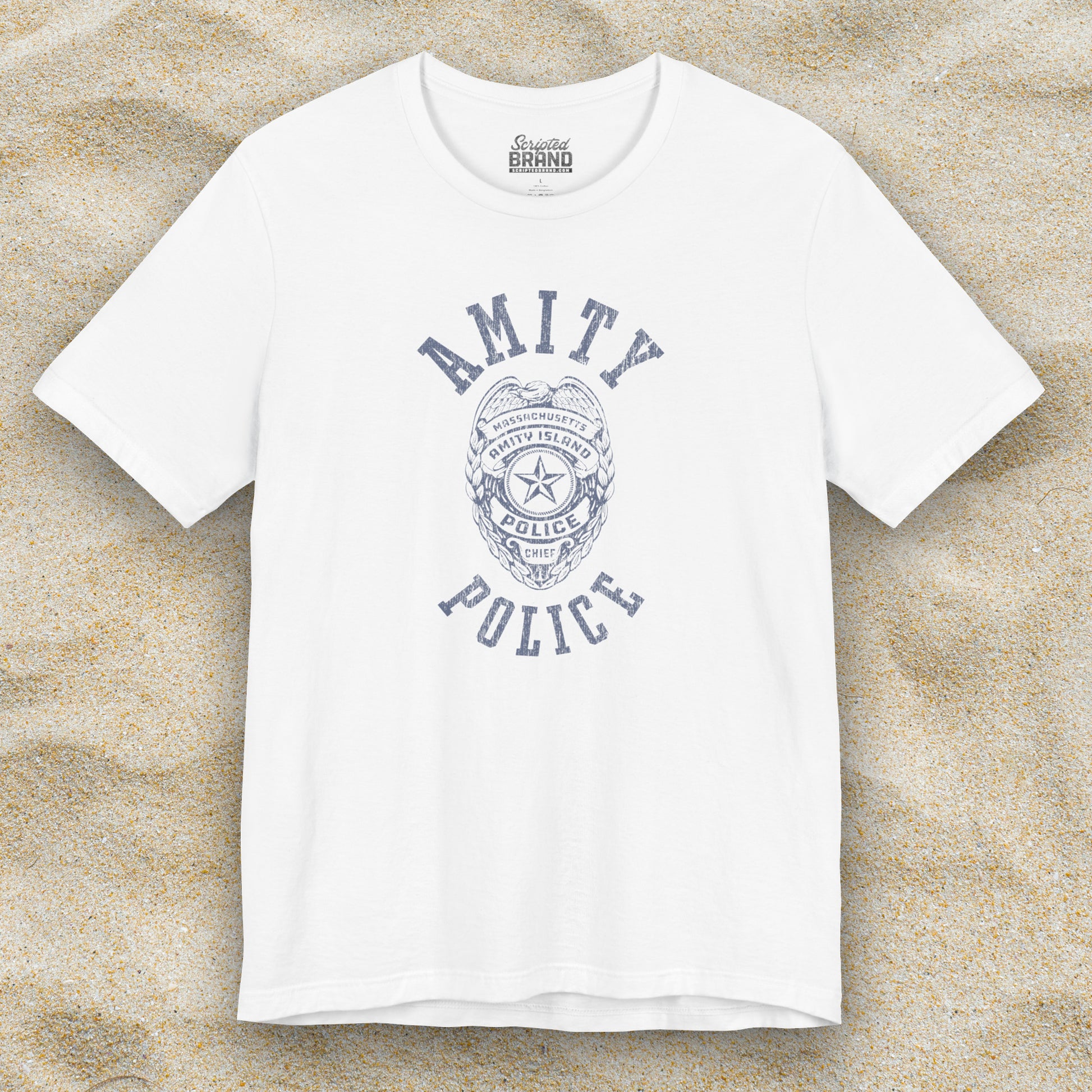 Front view of a white colored Soft unisex Bella+Canvas 3001 short-sleeve t-shirt featuring an Amity Island Police logo graphic, designed by ScriptedBrand, and  inspired by the movie Jaws in a vintage distressed style.