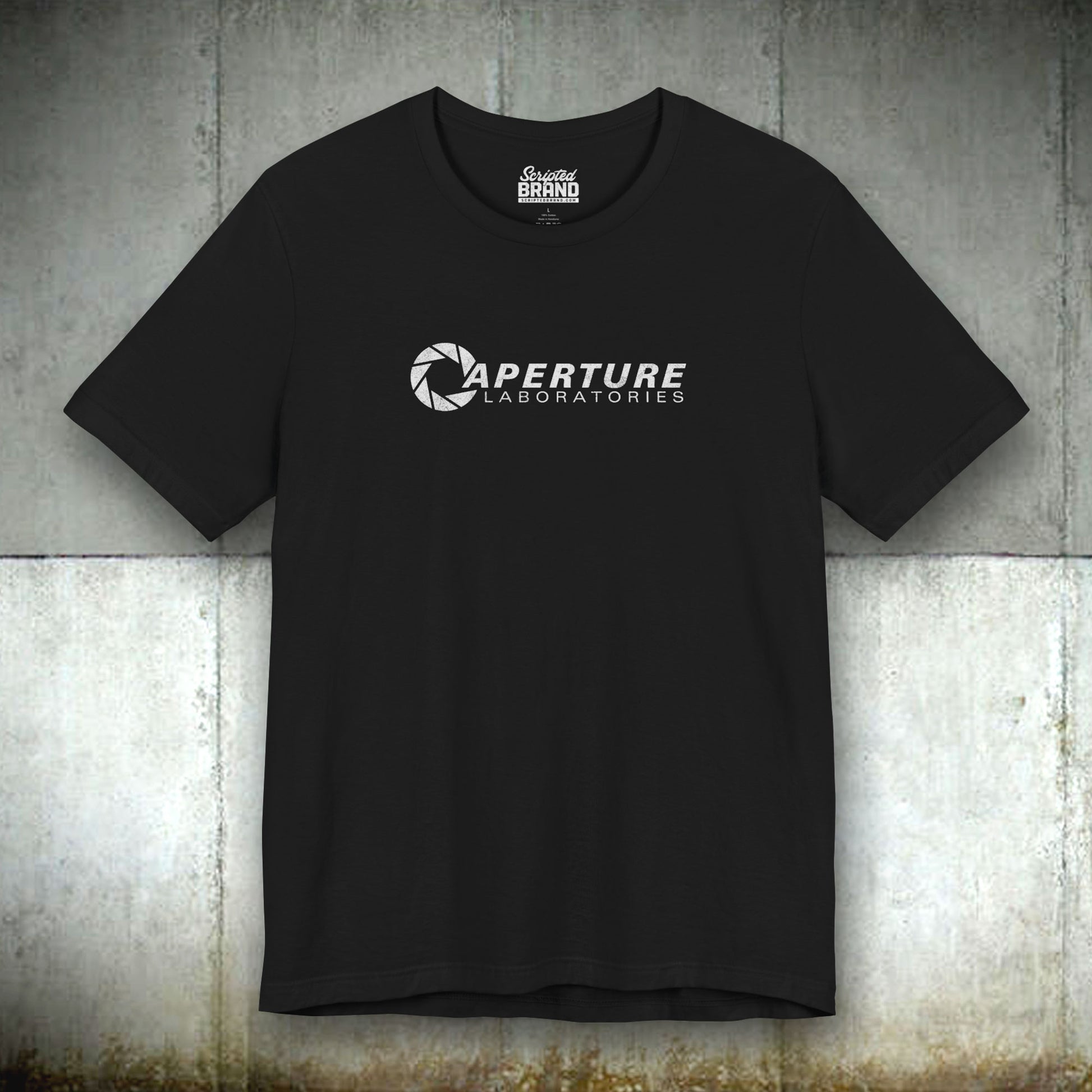 Black colored soft Bella+Canvas t-shirt with the Aperture Laboratories logo from the video game Portal and Portal 2 in a vintage ink-stamped distressed style. 

