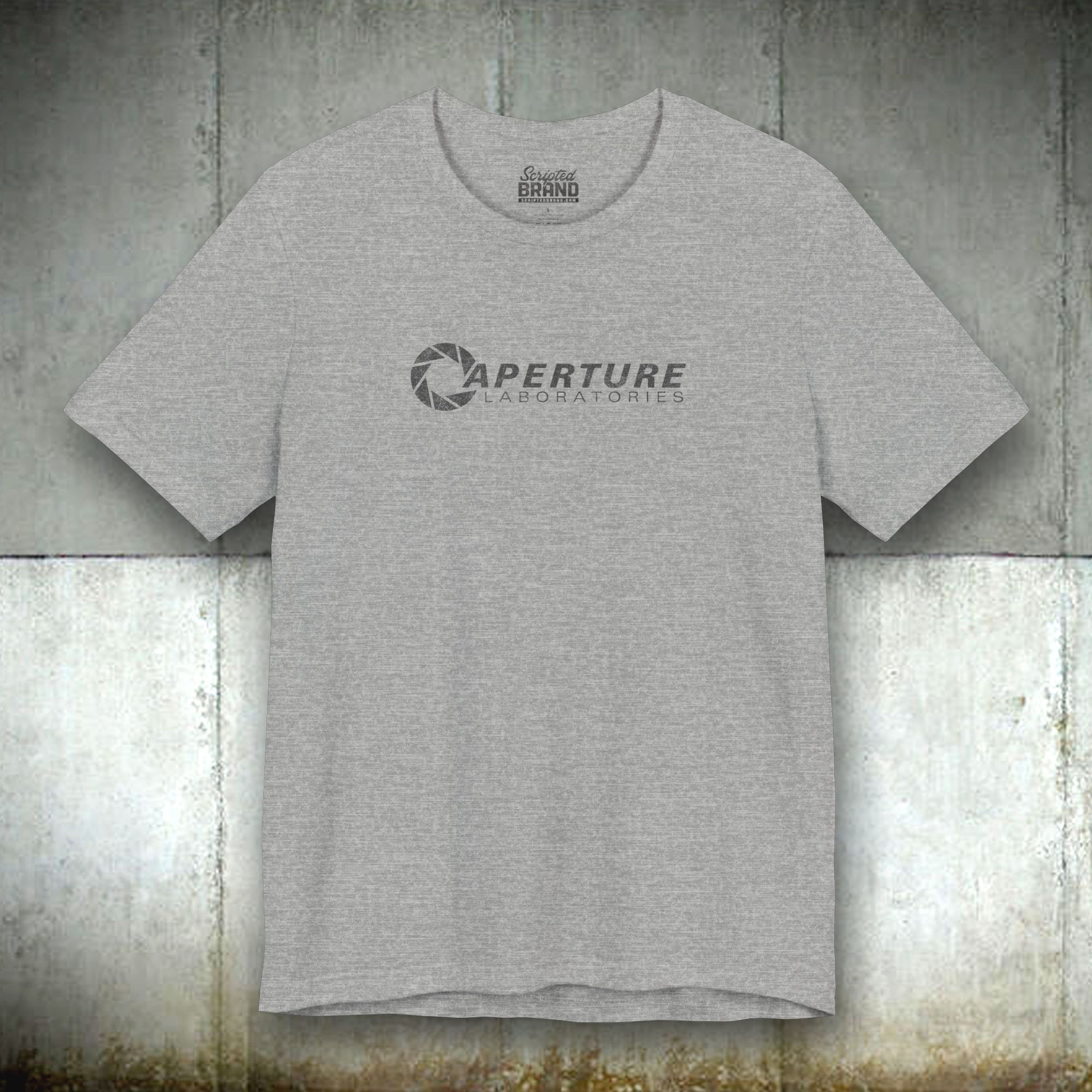 Athletic grey colored soft Bella+Canvas t-shirt with the Aperture Laboratories logo from the video game Portal and Portal 2 in a vintage ink-stamped distressed style. 