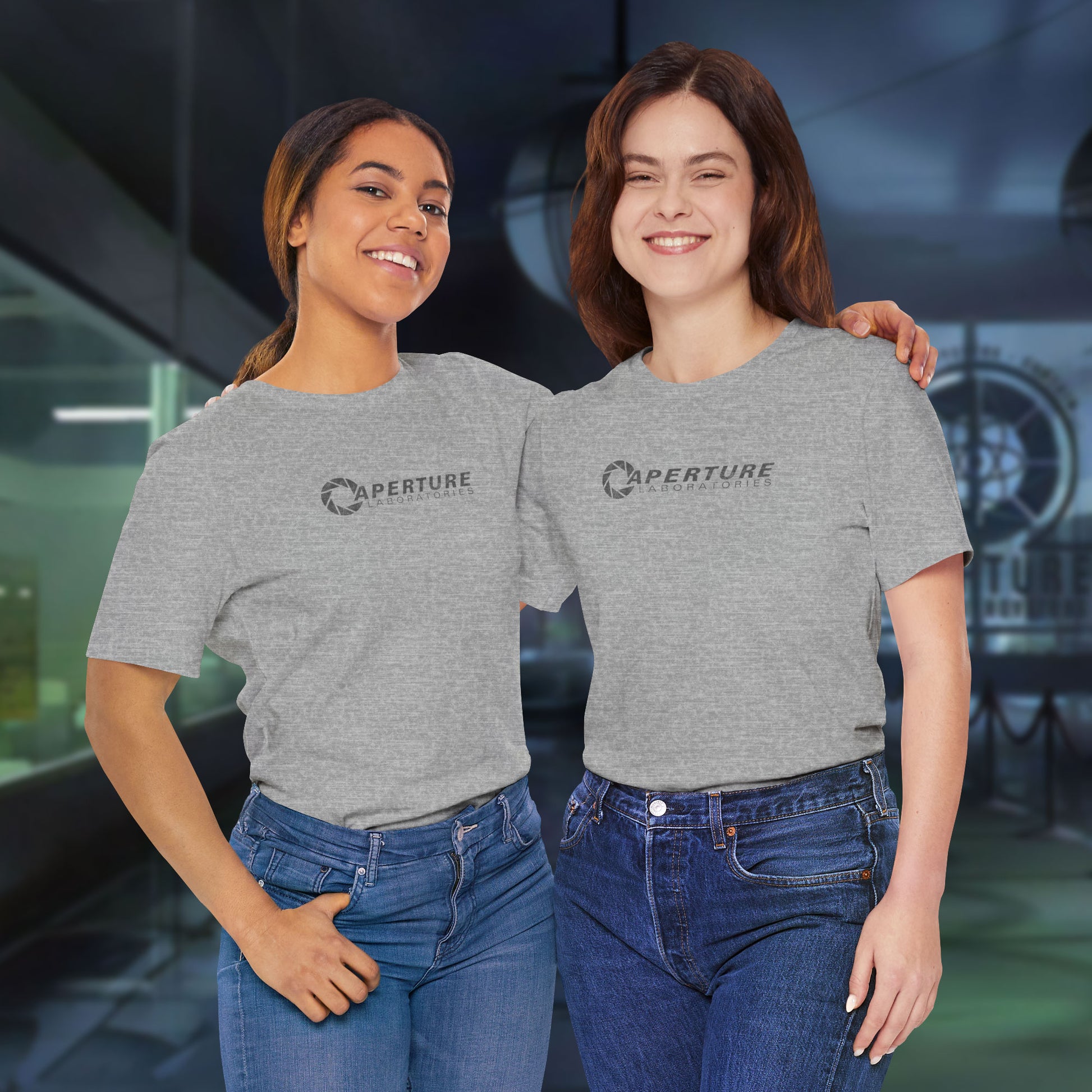 2 women models wearing athletic grey soft Bella+Canvas t-shirts with the Aperture Laboratories logo from the video game Portal and Portal 2 in a vintage ink-stamped distressed style. 