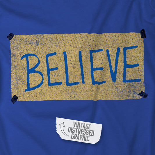 Closeup view of a royal blue colored soft Bella+Canvas 3001 short-sleeve t-shirt featuring a logo graphic of the BELIEVE sign Ted Lasso hung in the fictional English soccer team AFC Richmond locker room, inspired by the TV show Ted Lasso in a vintage distressed style, sold by ScriptedBrand.