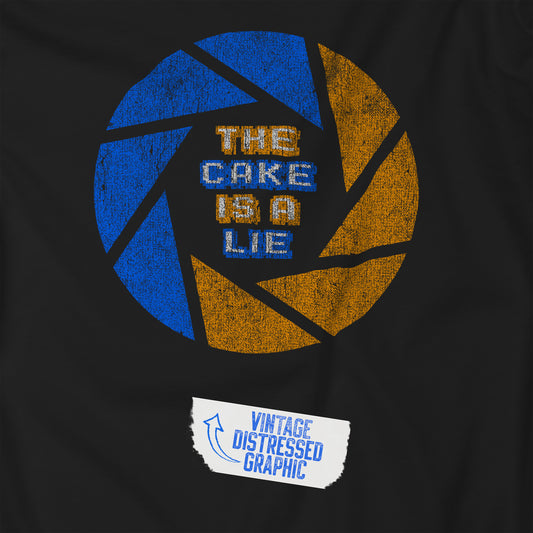 Closeup view of a black colored soft Bella+Canvas 3001 short-sleeve t-shirt featuring the phrase The Cake Is a Lie, along with the Aperture Laboratories shutter logo from the video game Portal and Portal 2 in a vintage distressed style, sold by ScriptedBrand.