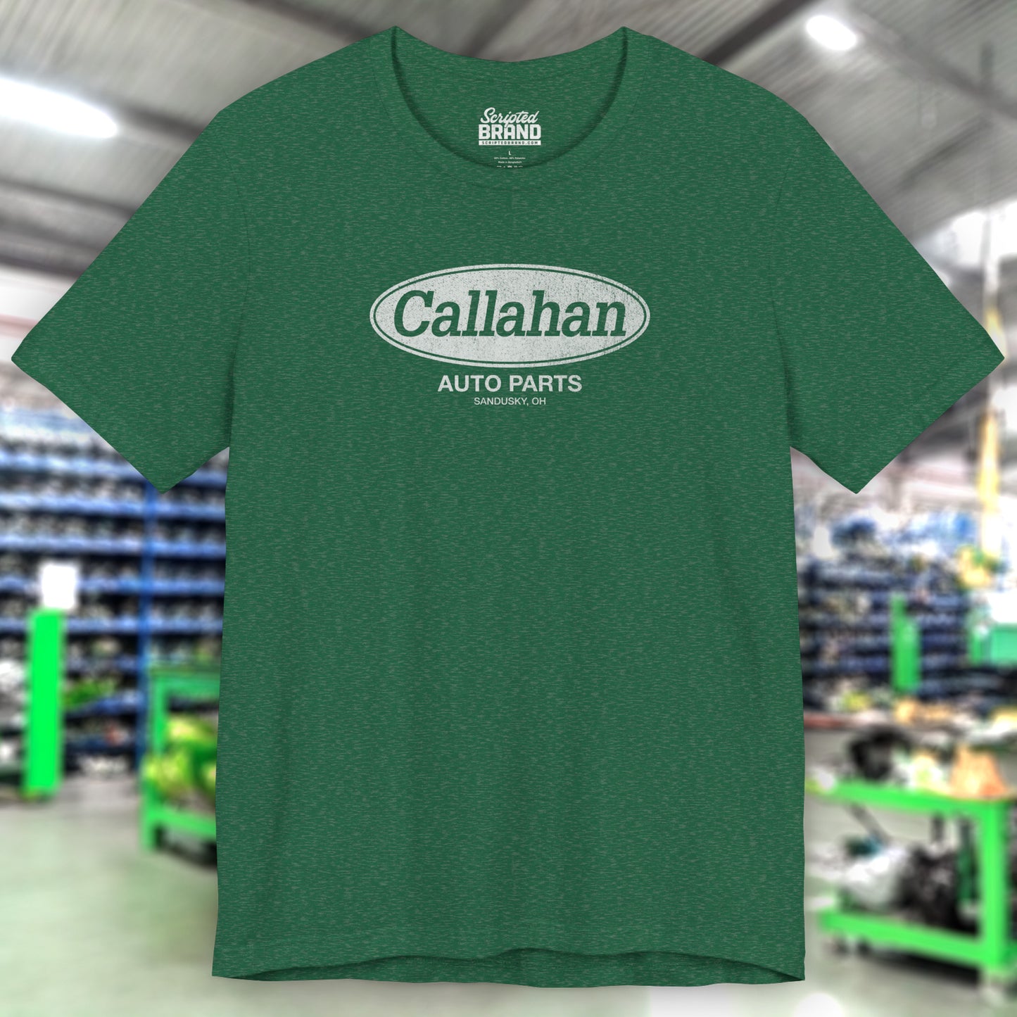 Front view of a Heather Grass Green t-shirt with the Callahan Auto Parts logo from the movie Tommy Boy in a vintage distressed style.