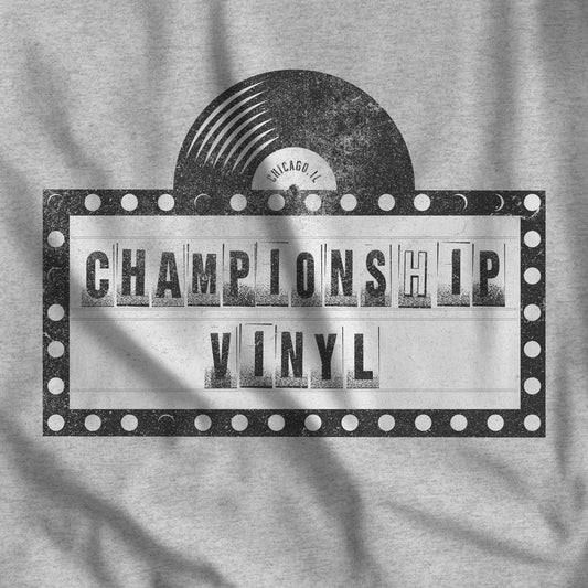 Closeup of Athletic Heather Grey t-shirt featuring the fictional logo CHAMPIONSHIP VINYL record store from movie High Fidelity in a vintage distressed style.