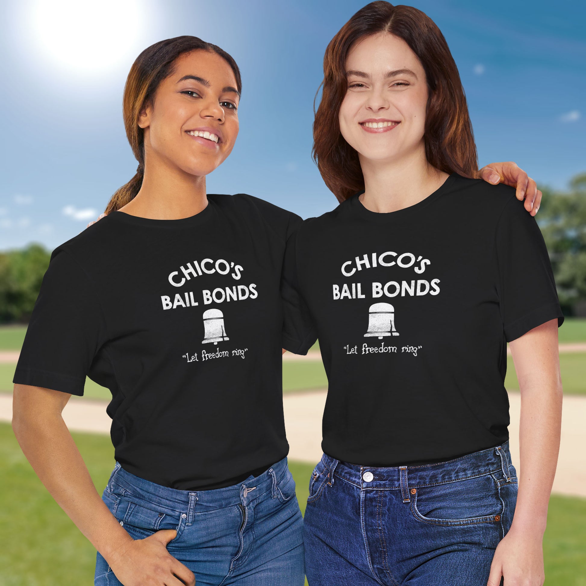2 models wearing black t-shirts with distressed Chico’s Bail Bonds logo and “Let freedom ring” slogan from The Bad News Bears movie.