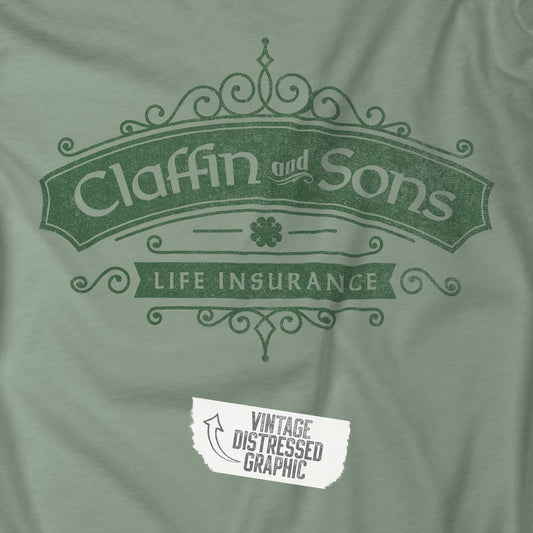 Closeup of a sage colored soft Bella+Canvas 3001 short-sleeve t-shirt featuring a logo graphic of Claffin & Sons Insurance, designed by ScriptedBrand in a vintage distressed vintage distressed style, inspired by the TV show Bad Sisters.