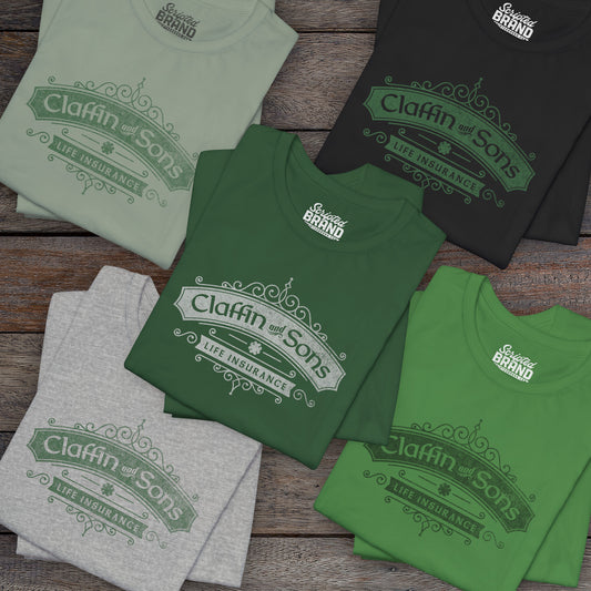 Group of 5 folded soft Bella+Canvas 3001 short-sleeve t-shirts featuring a logo graphic of Claffin & Sons Insurance, designed by ScriptedBrand in a vintage distressed vintage distressed style, inspired by the TV show Bad Sisters.