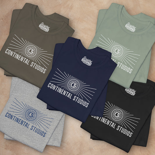 Group of 5 folded Soft Bella+Canvas 3001 short-sleeve t-shirts featuring the logo graphic of the fictional movie studio Continental Studios inspired by the Apple TV show The Studio in a vintage distressed style, sold by ScriptedBrand.