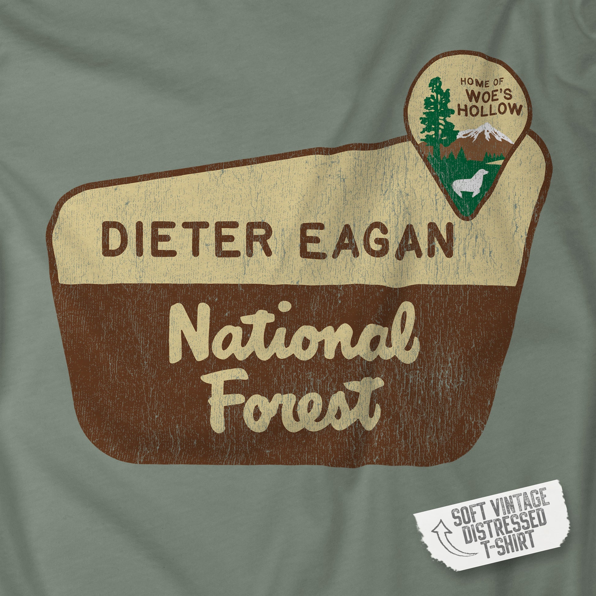 Closeup view of a logo graphic of the Dieter Eagan National Forest sign on a t-shirt, inspired by the TV show Severance, vintage distressed style.