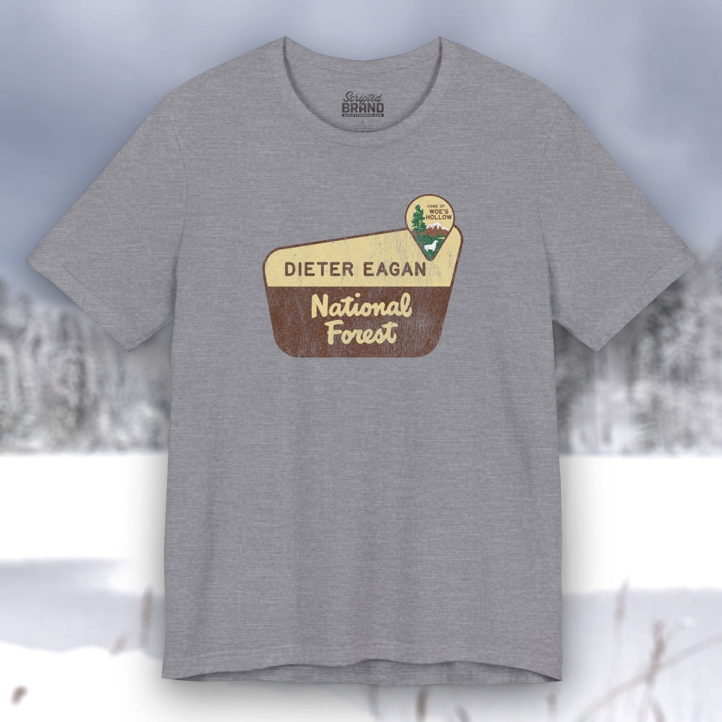 Heather Storm colored soft Bella+Canvas short-sleeve t-shirt with the logo graphic of the Dieter Eagan National Forest inspired by the TV show Severance in a vintage distressed ink-stamped worn-in style.