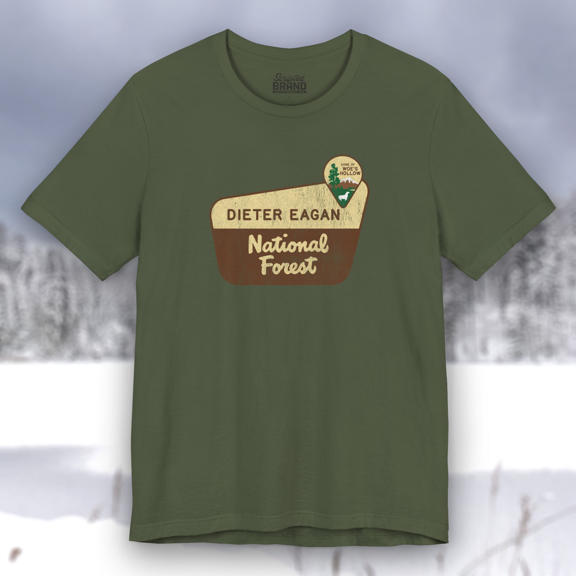 Military green colored soft Bella+Canvas short-sleeve t-shirt with the logo graphic of the Dieter Eagan National Forest inspired by the TV show Severance in a vintage distressed ink-stamped worn-in style.