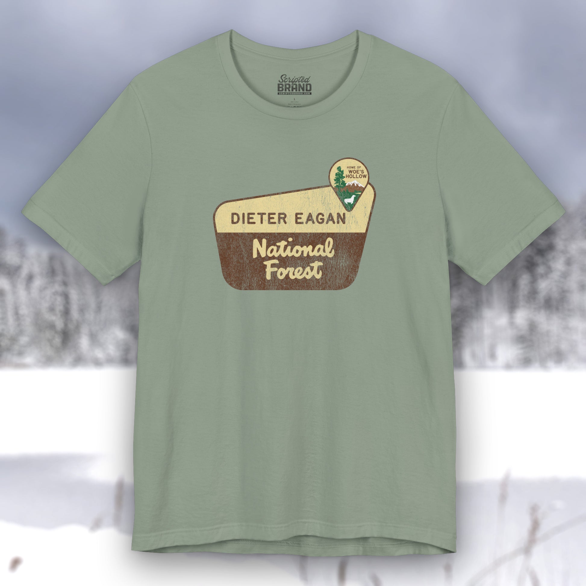 Sage green colored soft Bella+Canvas short-sleeve t-shirt with the logo graphic of the Dieter Eagan National Forest inspired by the TV show Severance in a vintage distressed ink-stamped worn-in style.