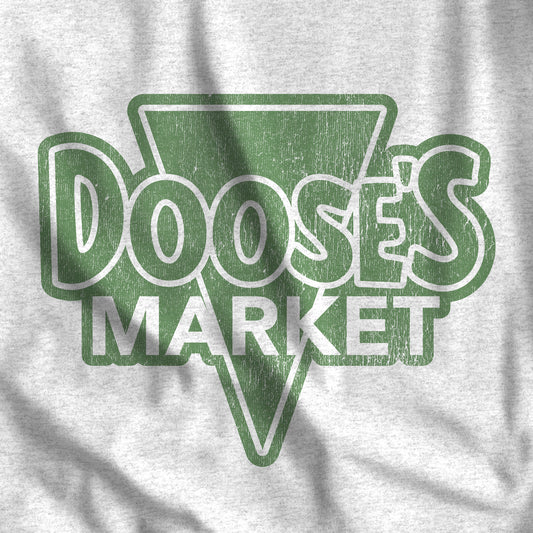 Closeup of Heather Gray Bella+Canvas t-shirt with a vintage-style Doose’s Market logo graphic in green, inspired by Gilmore Girls