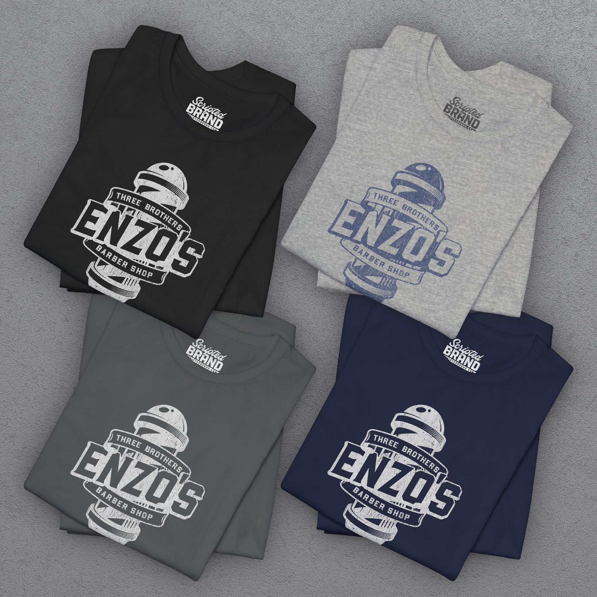 Four folded t-shirts with Enzo's Barber Shop logo graphic inspired by the TV show Seinfeld in a vintage distressed style.