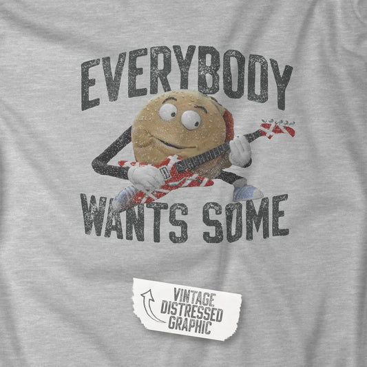Closeup of t-shirt with the phrase EVERYBODY WANTS SOME and a graphic of the guitar playing hamburger from the movie Better Off Dead in a vintage style.
