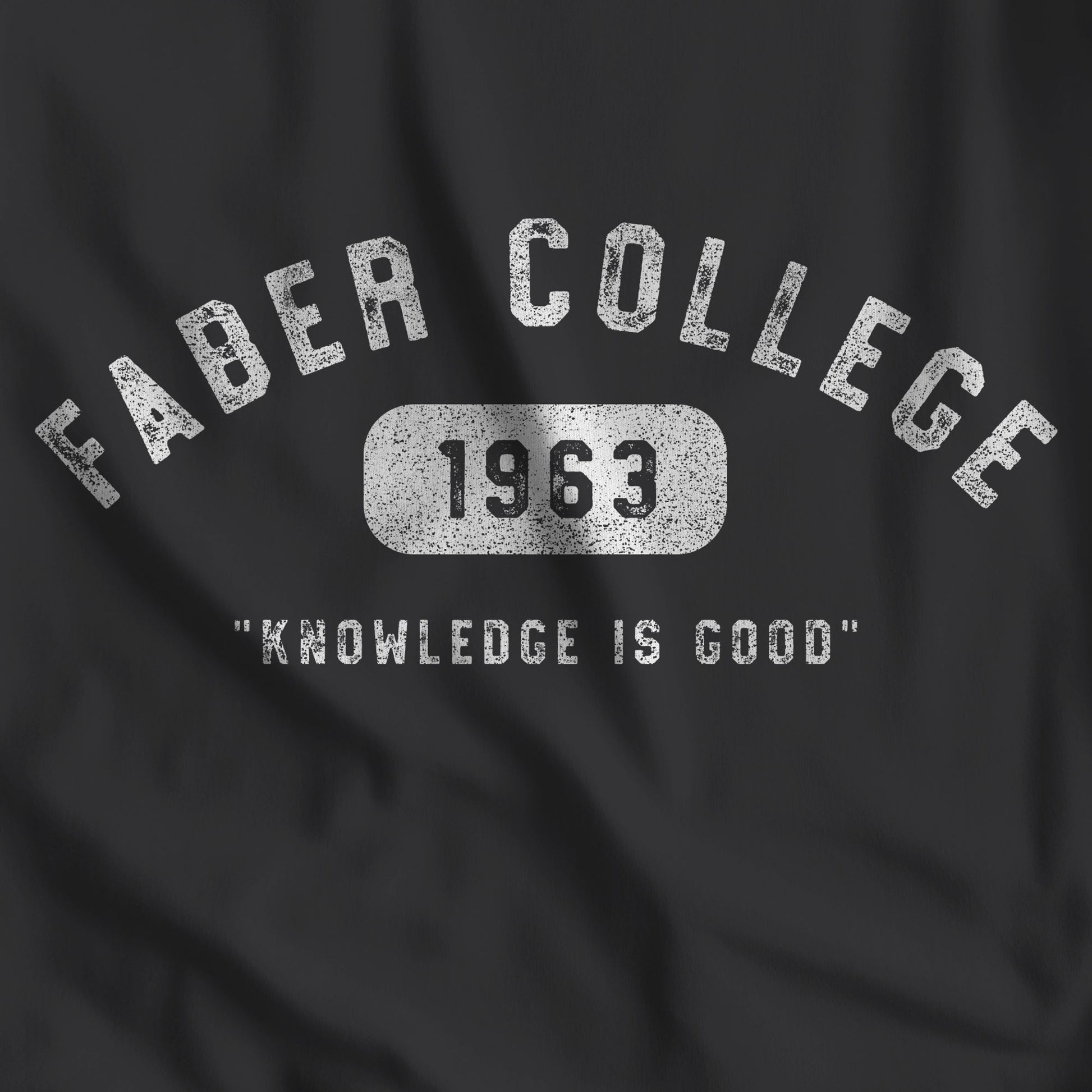 Closeup of black t-shirt with the Faber College logo and Knowledge Is Good from the movie Animal House in a vintage distressed style.