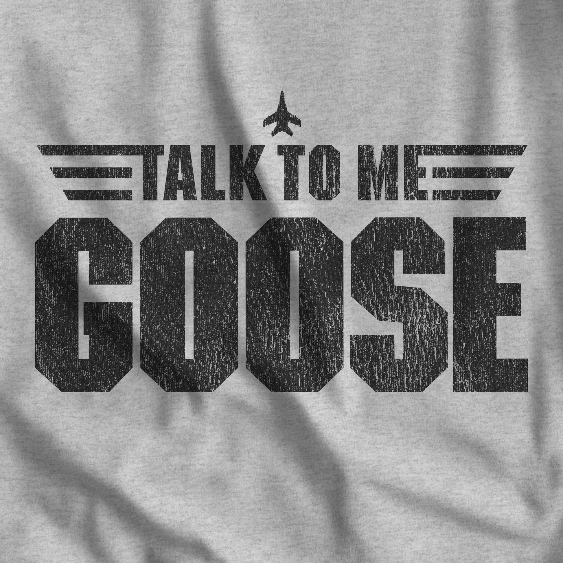 Closeup of a TALK TO ME GOOSE heather gray t-shirt inspired by the Movie Top Gun in a vintage distressed style.