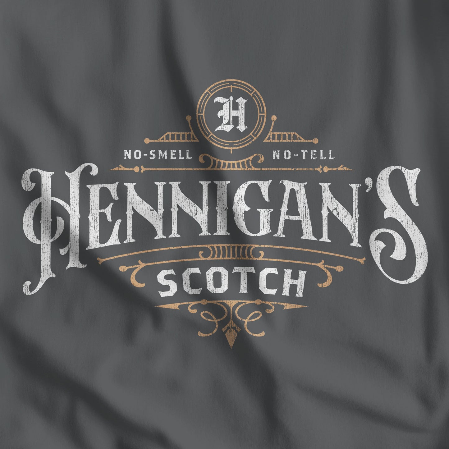 Dark gray t-shirt featuring a Hennigans Scotch Whisky logo graphic inspired by the TV show Seinfeld in a vintage distressed style.