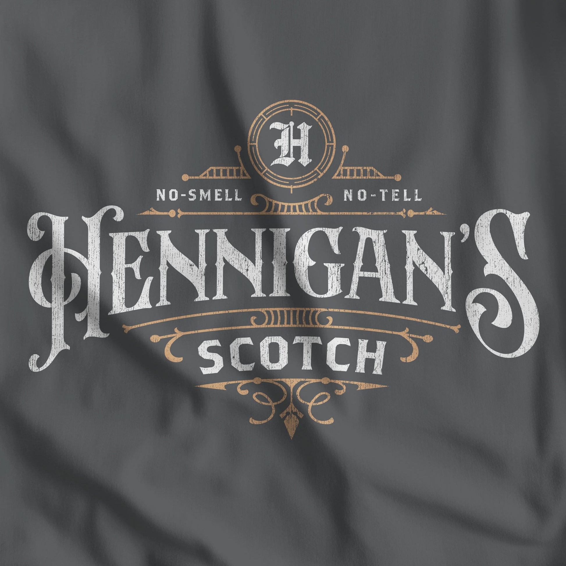 Dark gray t-shirt featuring a Hennigans Scotch Whisky logo graphic inspired by the TV show Seinfeld in a vintage distressed style.