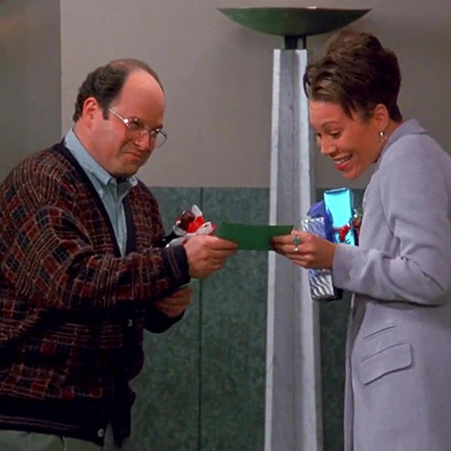 George Costanza handing out donation cards for The Human Fund in Seinfeld