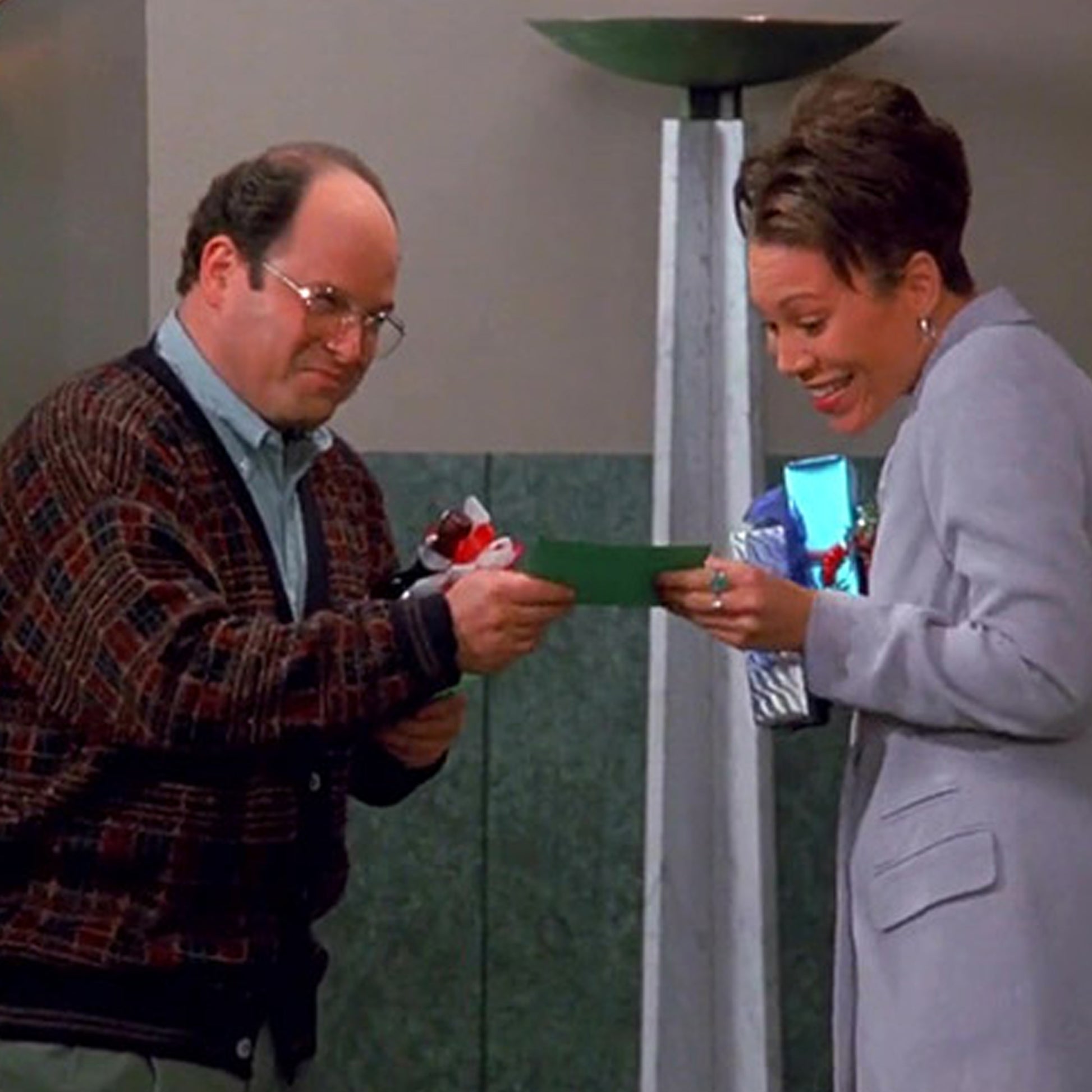 George Costanza handing out donation cards for The Human Fund in Seinfeld