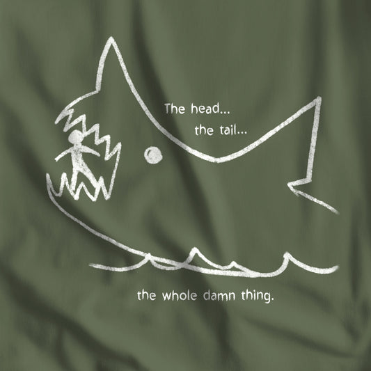 Closeup of Military Green colored Bella+Canvas t-shirt with the chalkboard drawing of a shark eating a person, drawn by Quint in the movie Jaws.