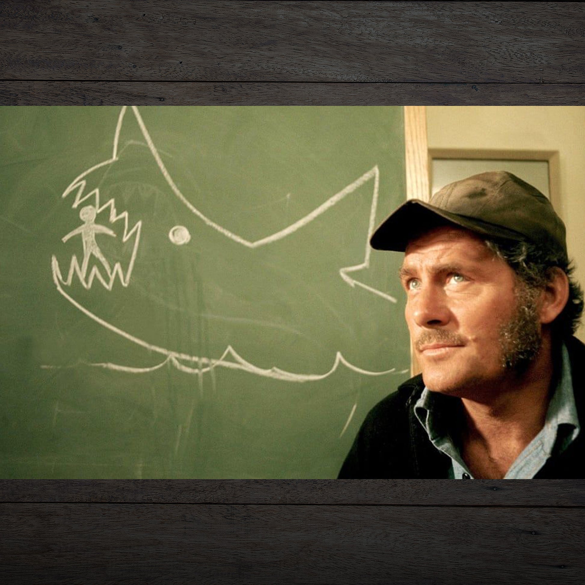 Scene from movie JAWS, a chalkboard drawing of a shark eating a person, drawn by Quint.