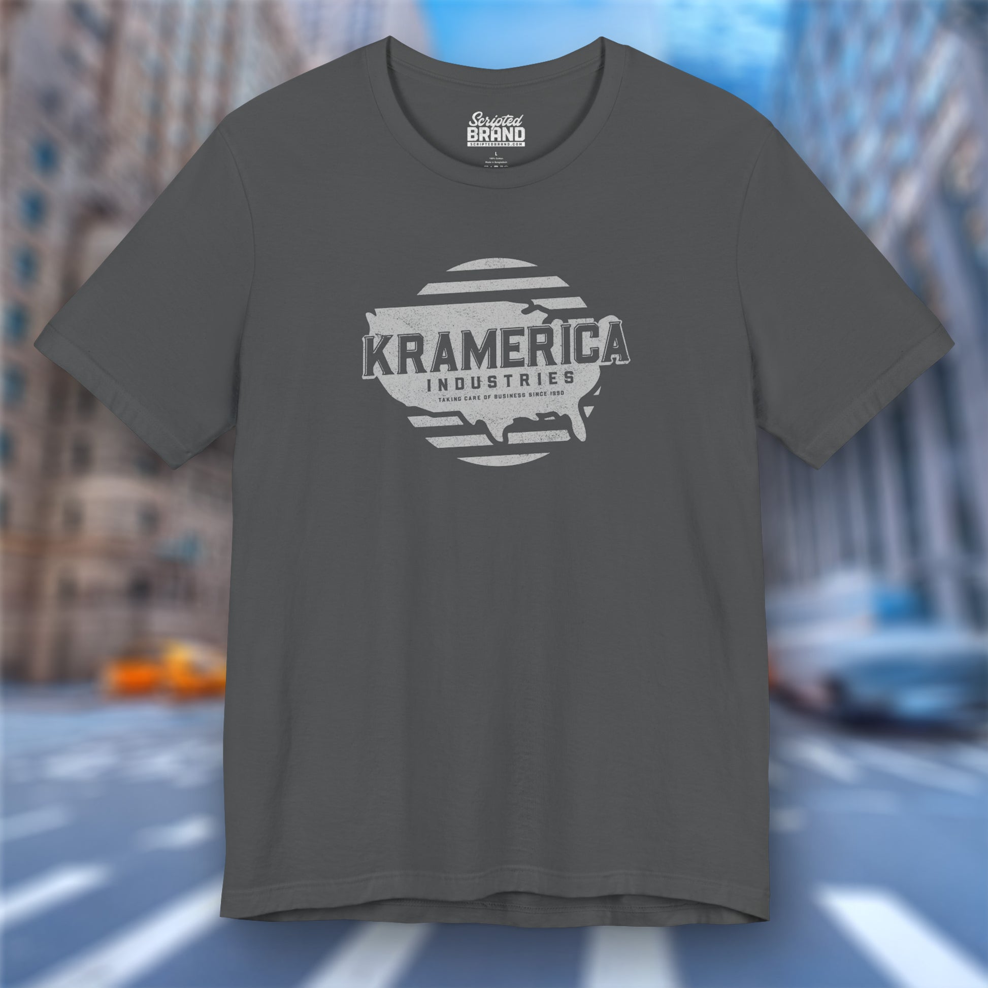 Asphalt dark gray t-shirt featuring a Kramerica logo graphic inspired by the TV show Seinfeld in a vintage distressed style.
