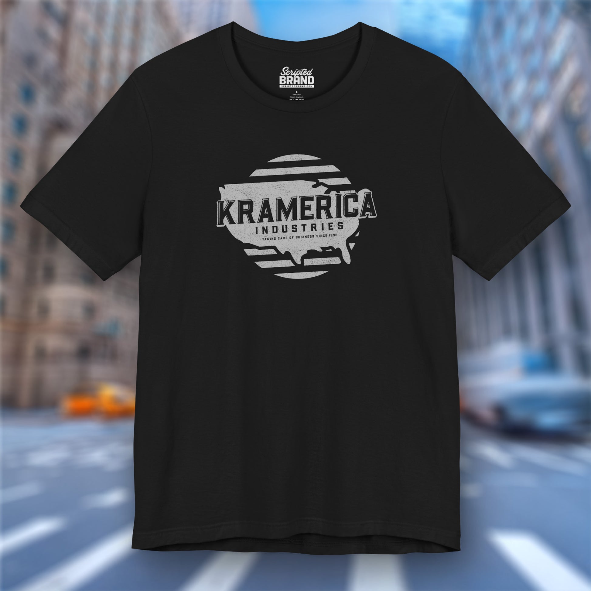 Black t-shirt featuring a Kramerica logo graphic inspired by the TV show Seinfeld in a vintage distressed style.
