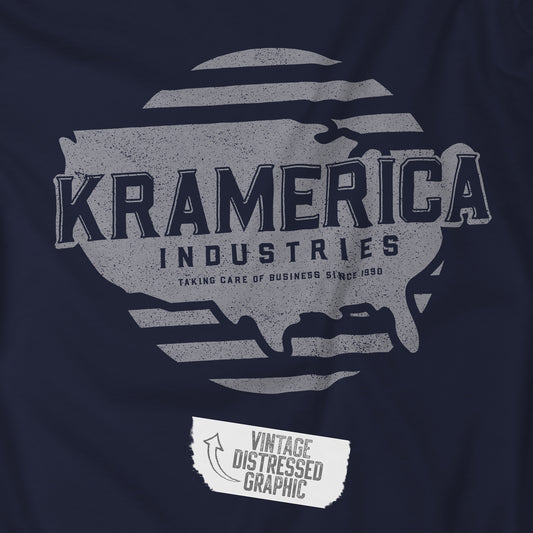 Closeup view of a navy blue soft unisex Bella+Canvas 3001 short-sleeve t-shirt featuring a unique Kramerica Industries logo graphic, designed by ScriptedBrand in a vintage distressed style, and inspired by the TV show Seinfeld.