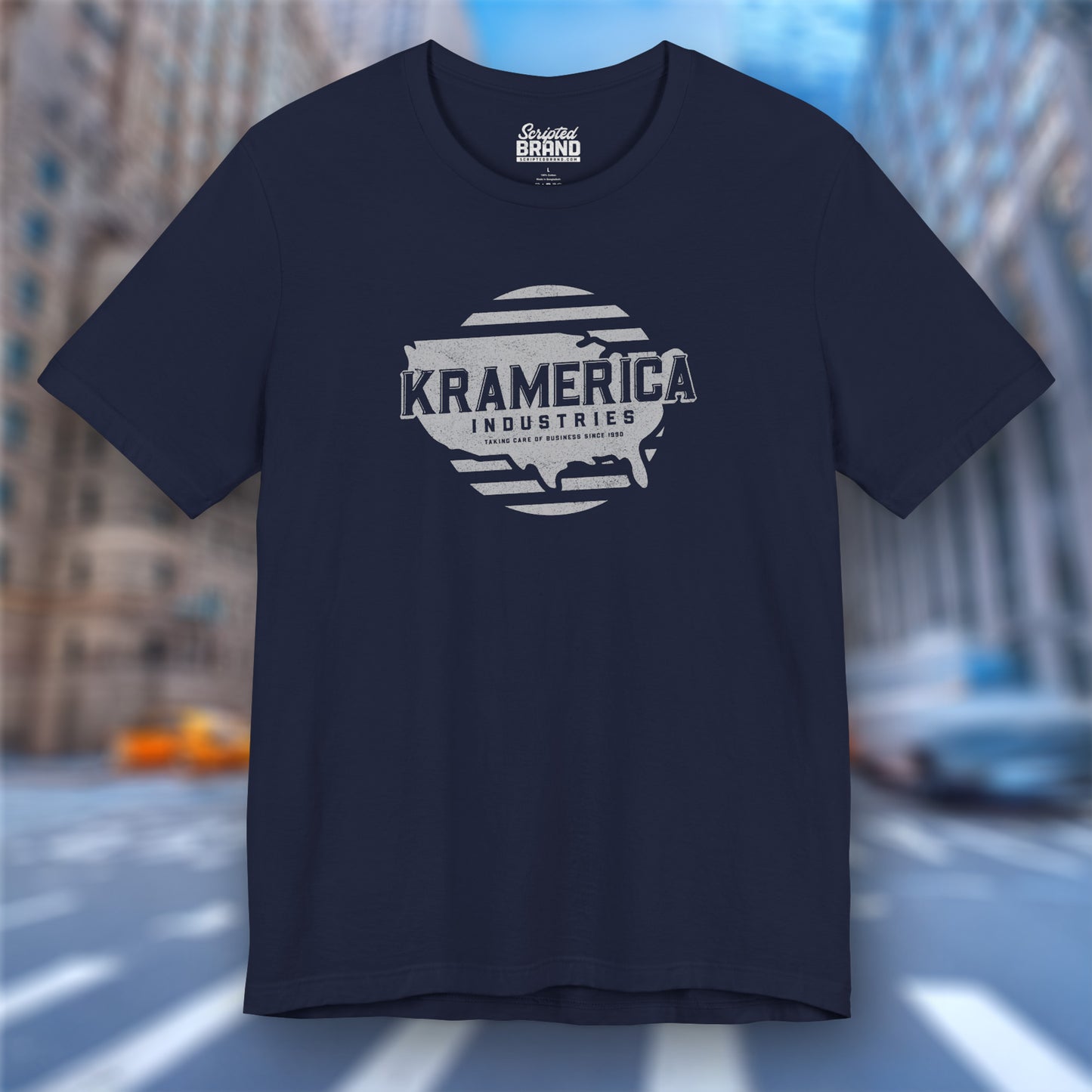 Navy blue t-shirt featuring a Kramerica logo graphic inspired by the TV show Seinfeld in a vintage distressed style.