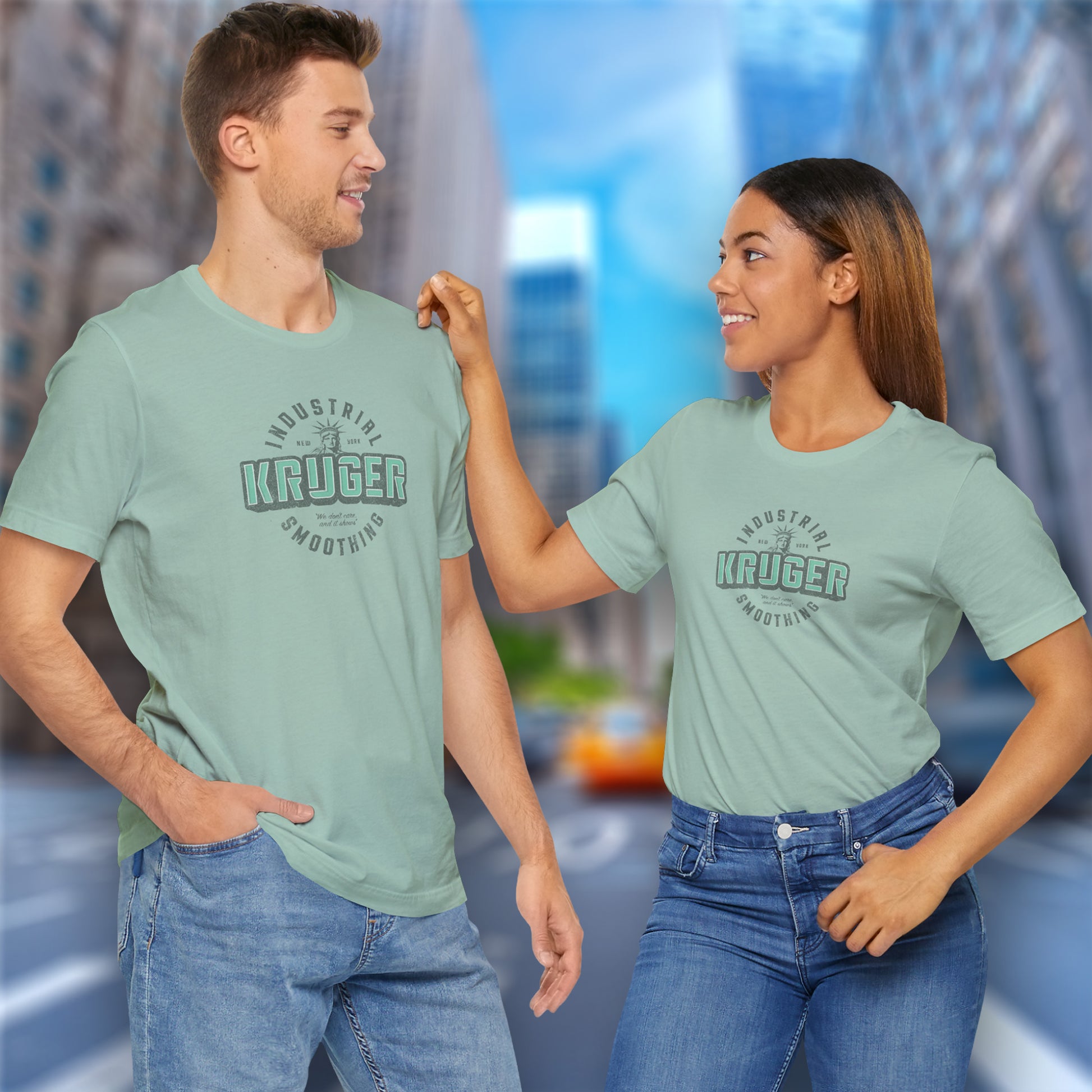 2 models wearing dusty blue colored Soft unisex Bella+Canvas 3001 short-sleeve t-shirt featuring a Kruger Industrial Smoothing logo graphic in a vintage distressed style, designed by ScriptedBrand, and  inspired by the TV show Seinfeld.