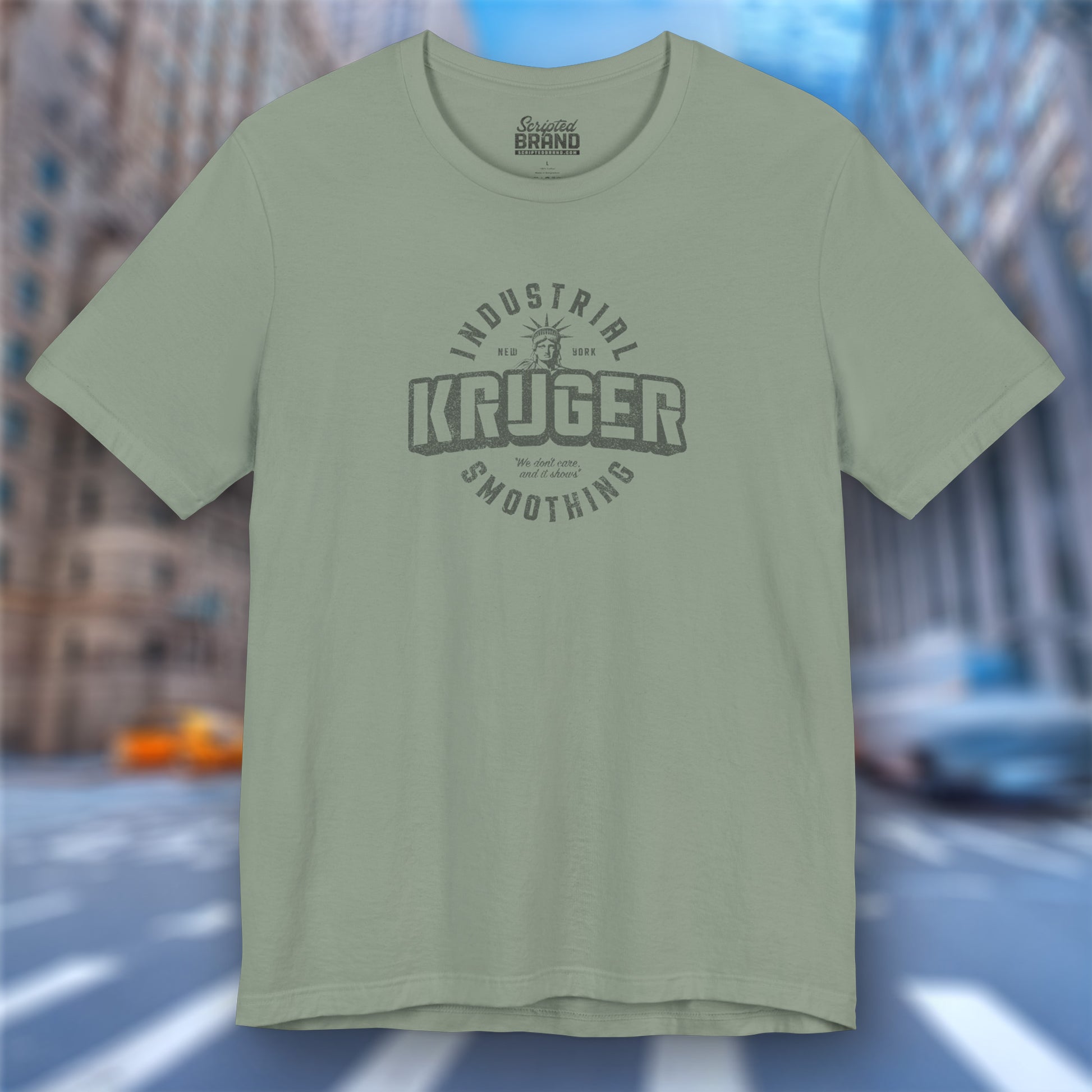 Front view of a sage green colored Soft unisex Bella+Canvas 3001 short-sleeve t-shirt featuring a Kruger Industrial Smoothing logo graphic in a vintage distressed style, designed by ScriptedBrand, and  inspired by the TV show Seinfeld.