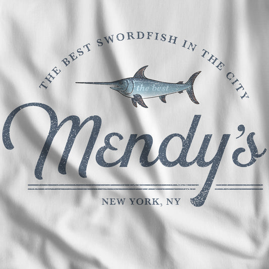 Closeup of white t-shirt featuring a Mendy's Restaurant logo graphic inspired by the TV show Seinfeld in a vintage style.