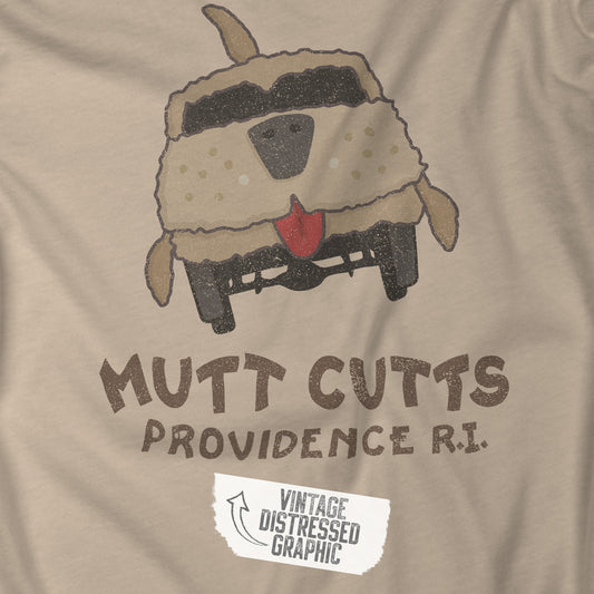 Closeup of a tan colored Soft unisex Bella+Canvas 3001 short-sleeve t-shirt featuring a Mutt Cutts logo graphic inspired by the movie Dumb and Dumber, illustrated by ScriptedBrand in a vintage distressed style.