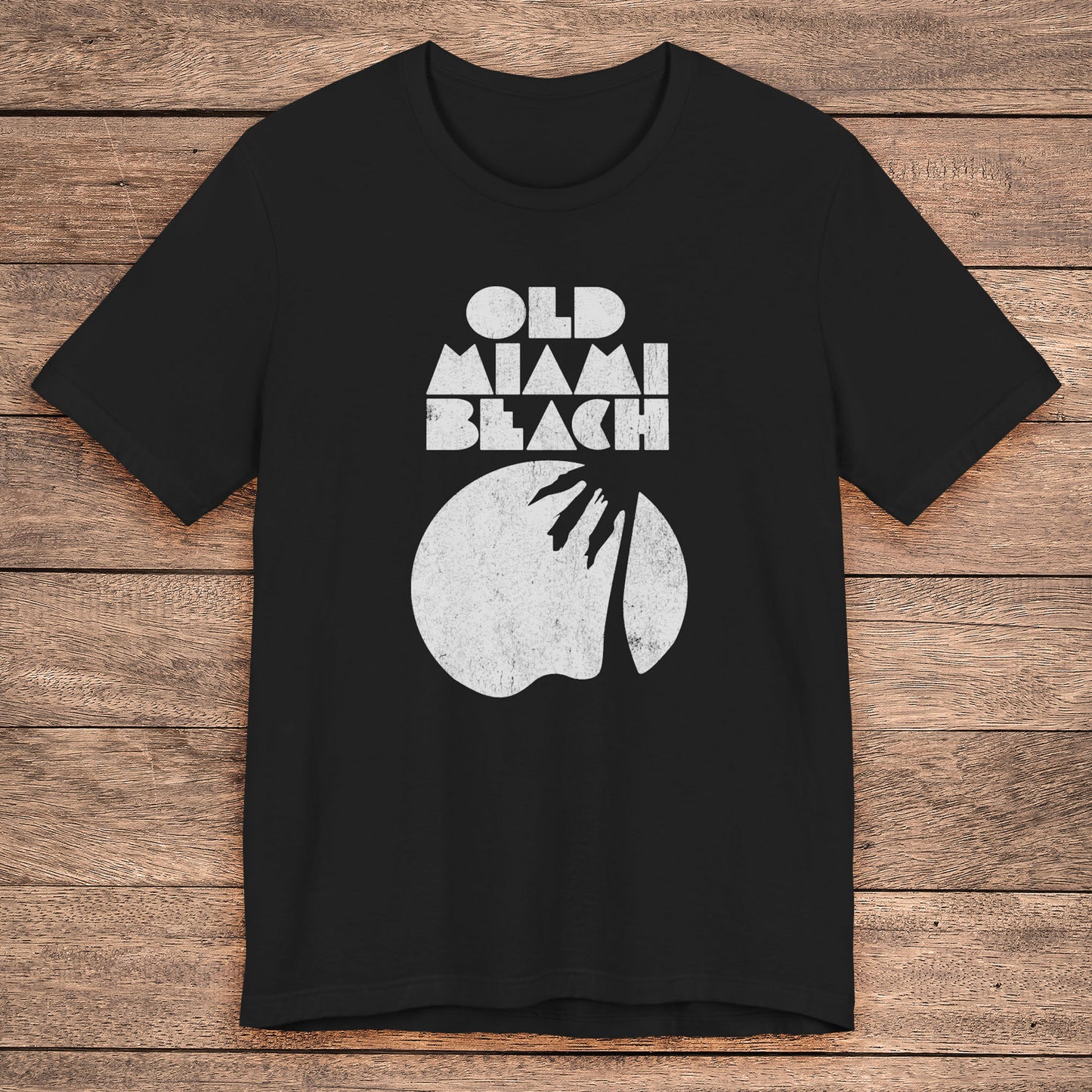 Black Bella+Canvas 3001 T-shirt with distressed “Old Miami Beach” graphic, inspired by Julia Garner’s shirt in Weapons movie.
