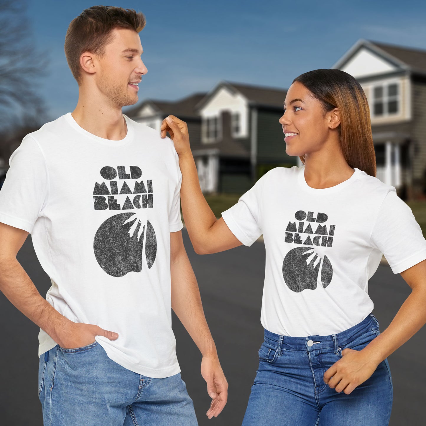 Two people wearing white Bella+Canvas 3001 T-shirt with distressed “Old Miami Beach” graphic, inspired by Julia Garner’s shirt in Weapons movie.