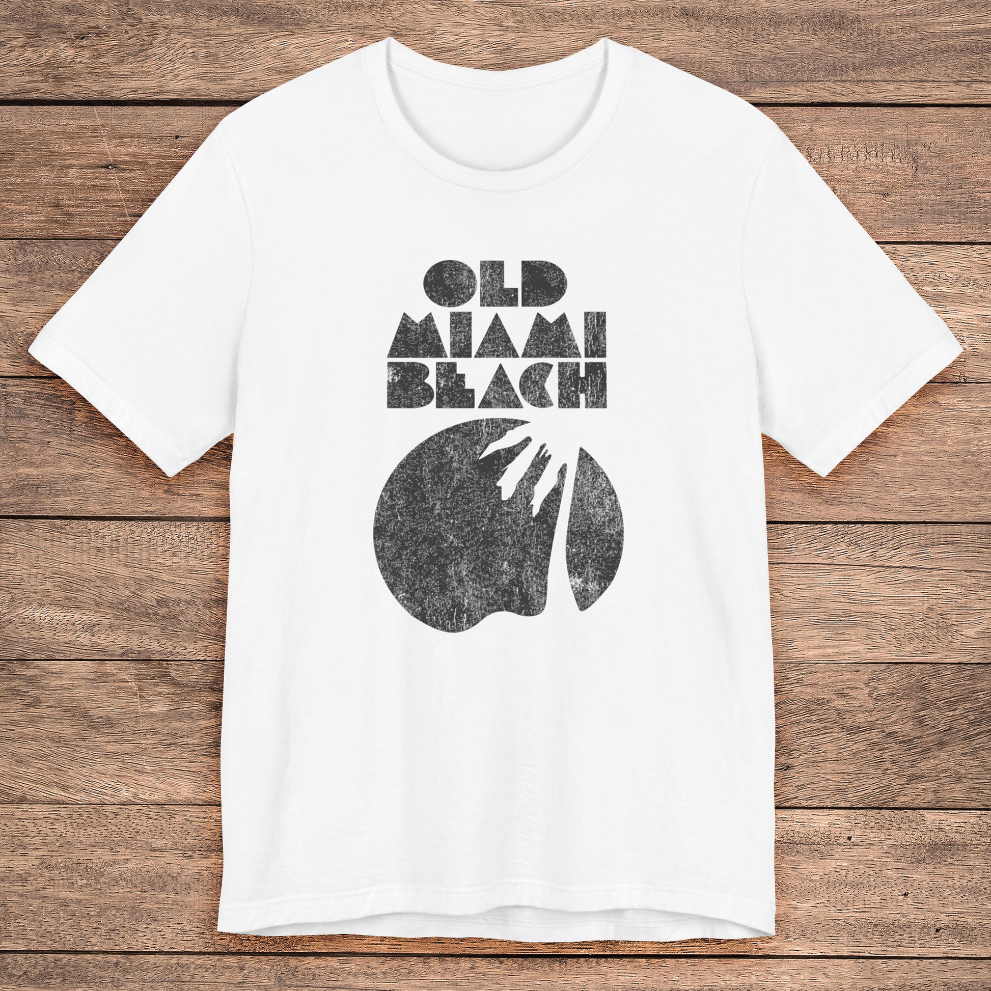 White Bella+Canvas 3001 T-shirt with distressed “Old Miami Beach” graphic, inspired by Julia Garner’s shirt in Weapons movie.