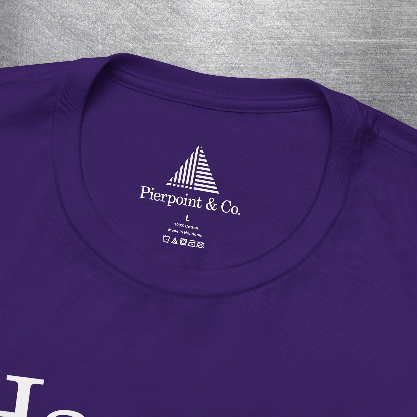 Closeup of neck tag on Purple t-shirt with names Harper, Eric, Yasmin, Robert & Rishi in Pierpoint & Co. font, inspired by TV show Industry.