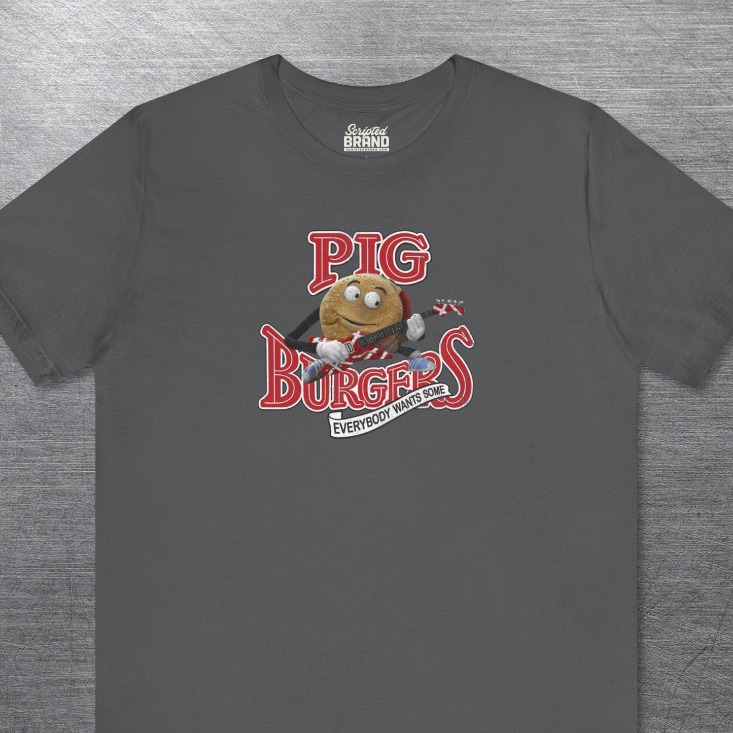 Asphalt soft Bella Canvas Tee featuring vintage Pig Burgers logo with Van Halen guitar from the movie Better Off Dead.