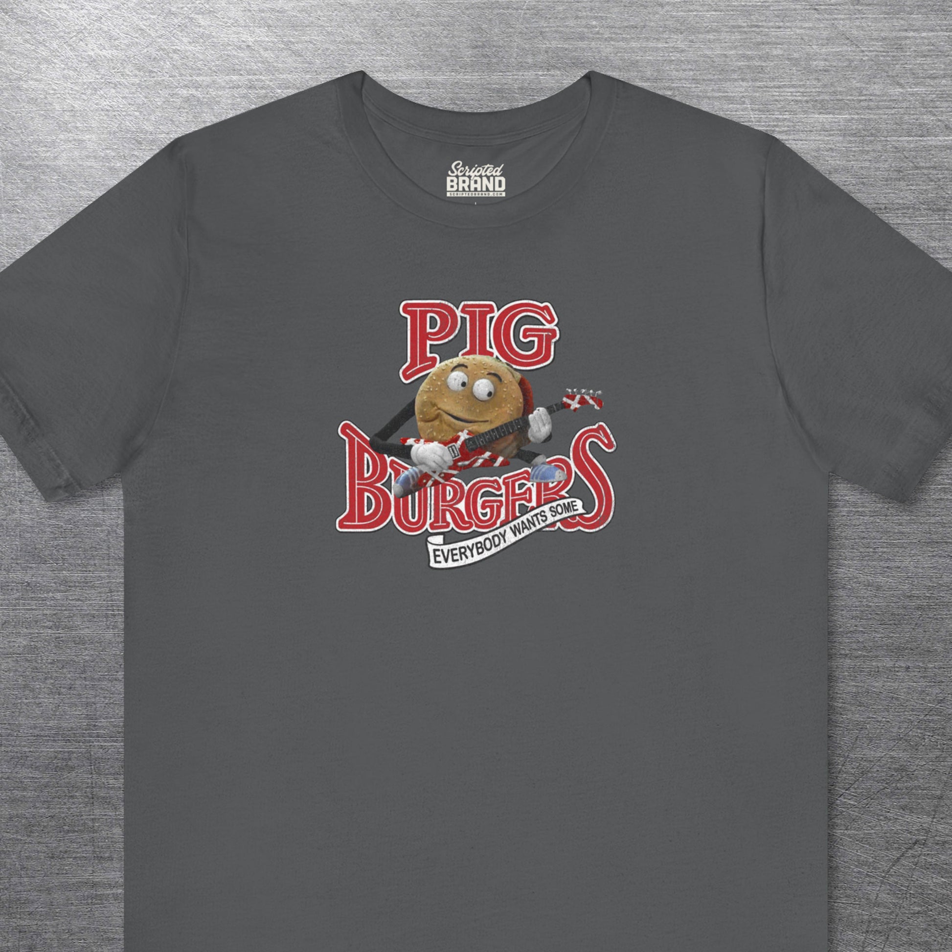 Asphalt soft Bella Canvas Tee featuring vintage Pig Burgers logo with Van Halen guitar from the movie Better Off Dead.