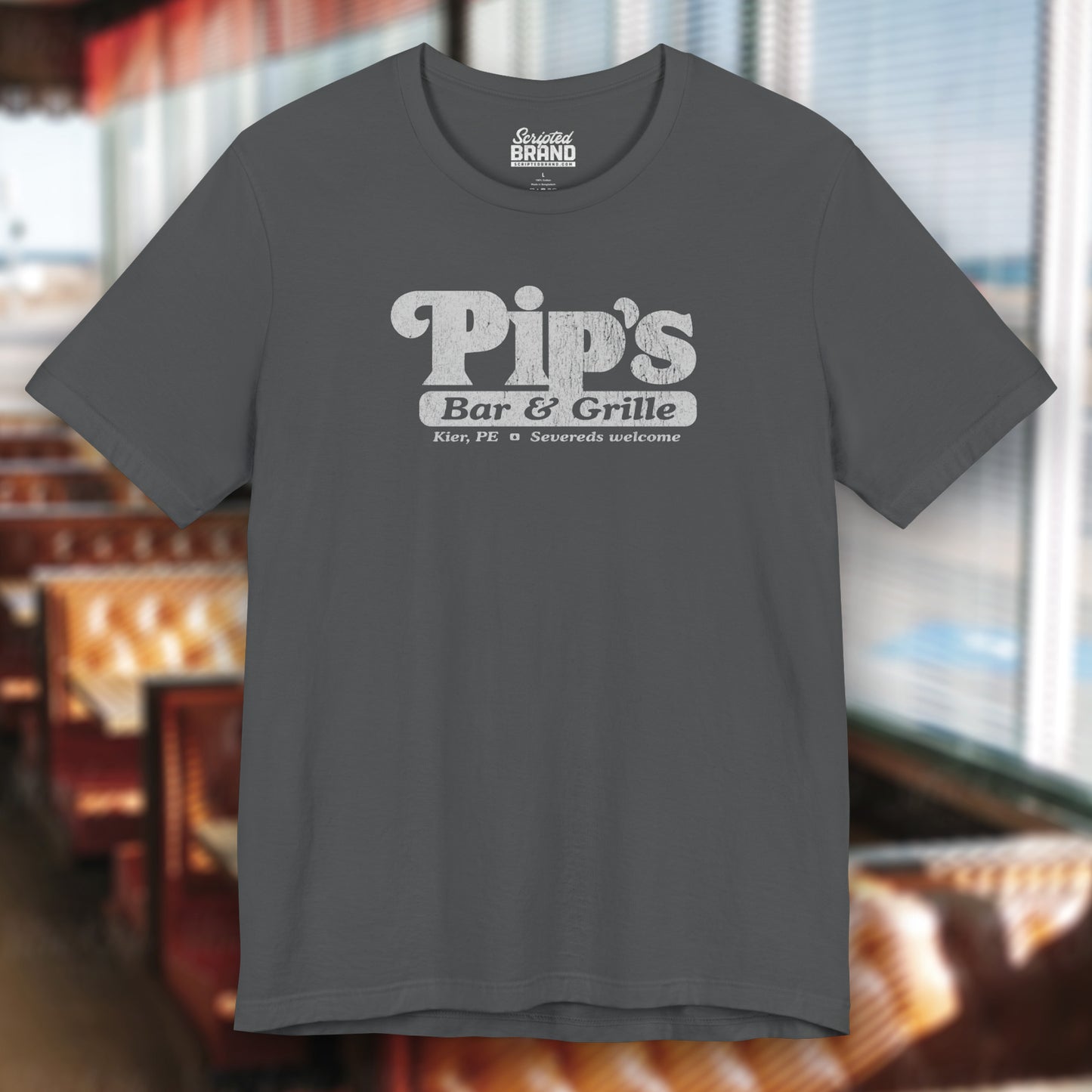 Asphalt Gray colored soft Bella+Canvas shirtsleeve t-shirt with the Pips Bar and Grill logo from the TV show Severance in a vintage distressed ink-stamped worn-in style.