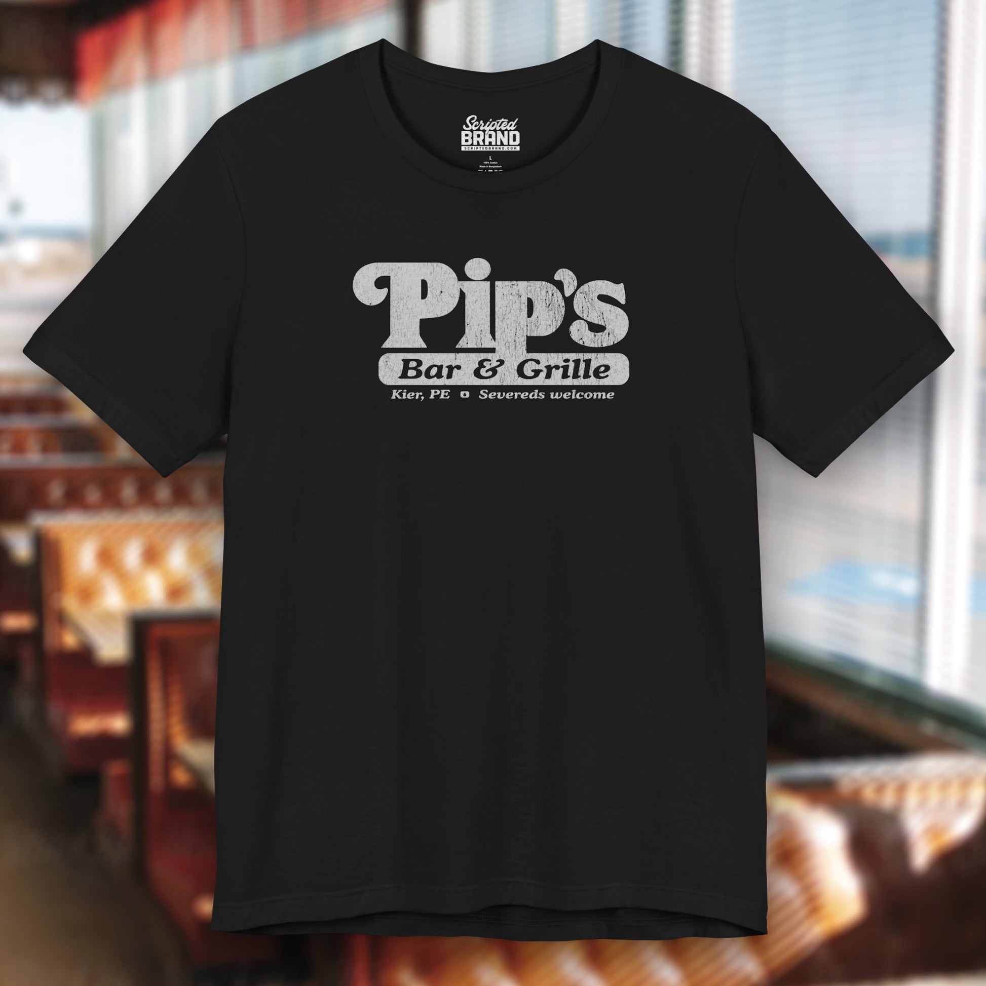 Black colored soft Bella+Canvas shirtsleeve t-shirt with the Pips Bar and Grill logo from the TV show Severance in a vintage distressed ink-stamped worn-in style.
